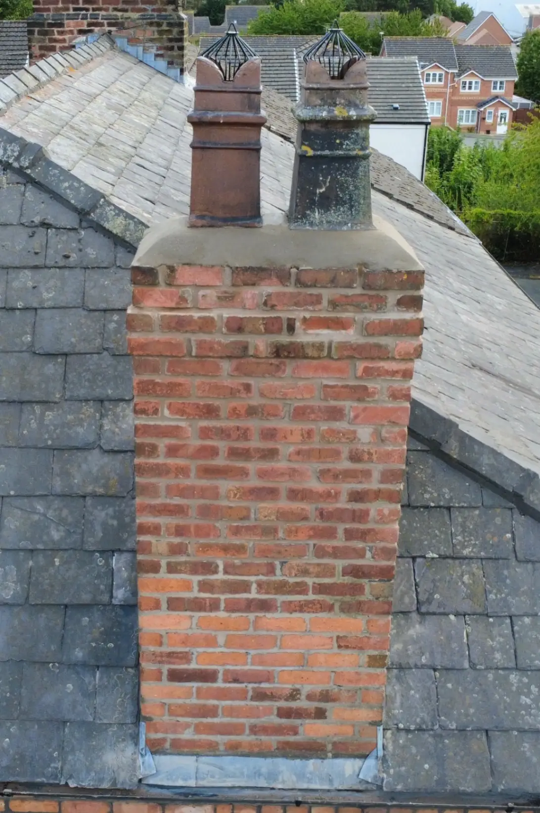 A repointed chimney with fresh flaunching and new bird guards