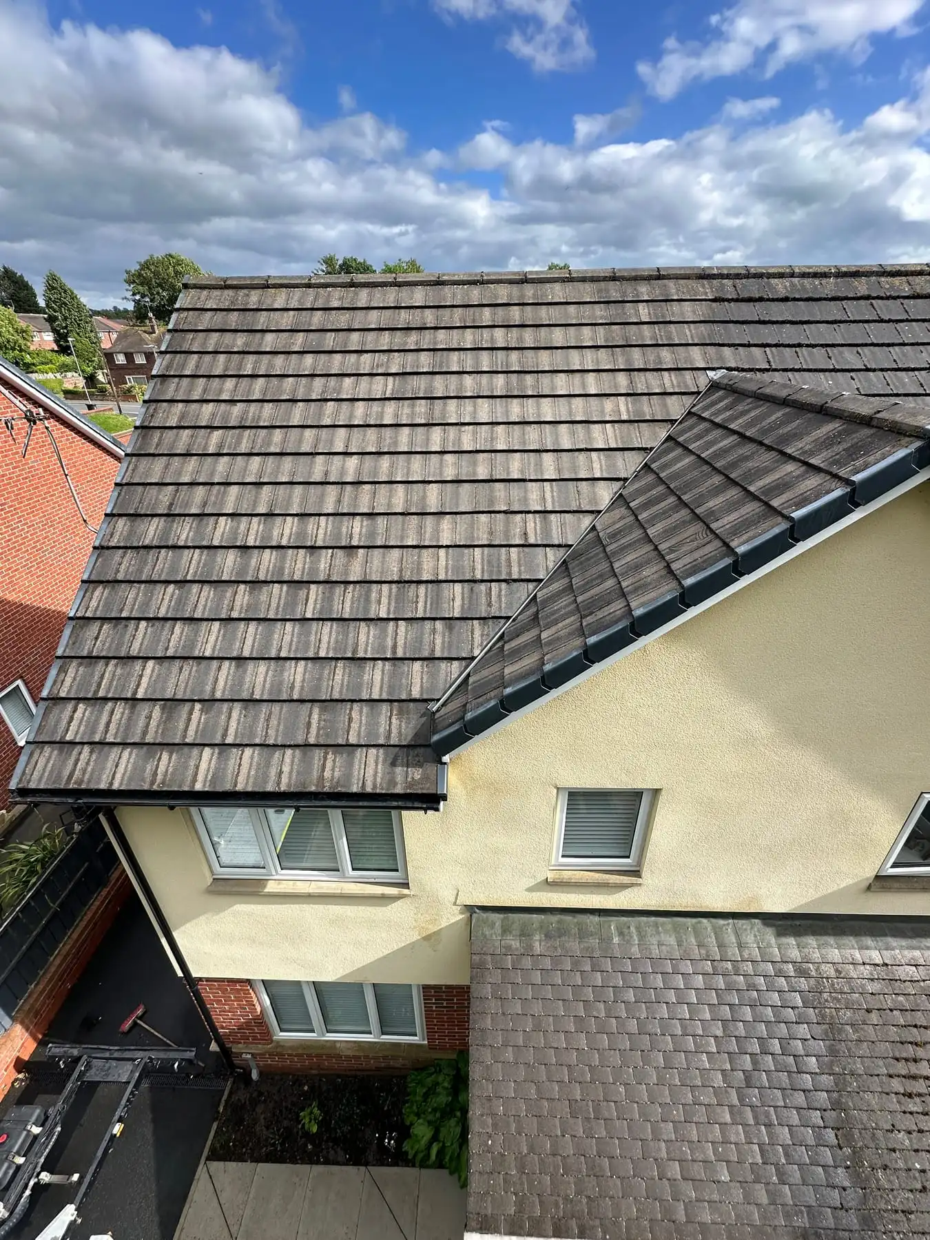 Freshly cleaned roof on a rendered house